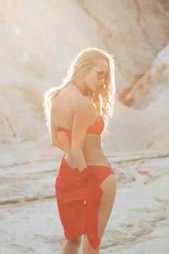 金发女郎女孩红色的泳衣海滩