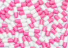 模糊粉红色的白色抗生素胶囊药片背景药店背景制药行业抗菌药物电阻概念爱情人节一天背景