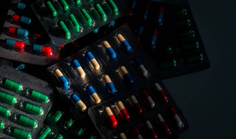 桩色彩斑斓的胶囊药片泡包黑暗背景药物政策预算抗生素药物合理的抗生素药物电阻概念禁忌症药片