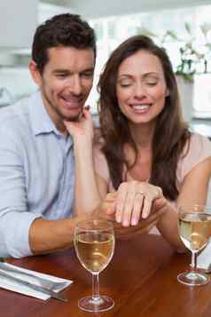 快乐女人显示订婚环男人。