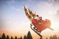 复合图像高角视图圣诞老人老人骑雪橇礼物盒子