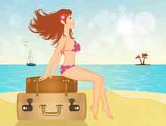 女孩坐着手提箱海滩