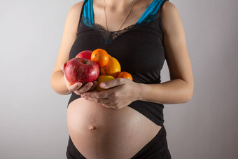 怀孕健康的有机营养怀孕了女人持有新鲜的维生素水果免费的空间的地方文本概念期望健康