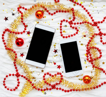 智能手机冬天假期背景圣诞节一年背景沟通设备蜂窝圣诞节装饰红色的黄色的俗丽的明星闪光珠子
