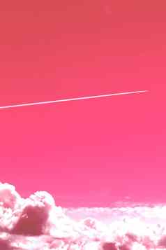 小道飞行飞机清晰的粉红色的天空大云