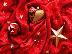 明亮的红色的织物圣诞节一年装饰金明星心球明星五彩纸屑折叠纺织背景