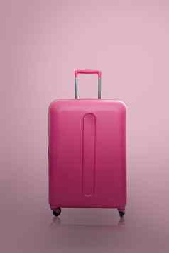 旅行者粉红色的手提箱小屋大小行李粉红色的背景