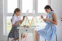 女孩学习油漆导师画窗口