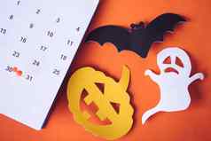 万圣节假期概念销日历事件规划南瓜鬼蝙蝠减少纸橙色背景