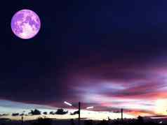 紫色的月亮色彩斑斓的天空橙色黑暗灰色的云轮廓