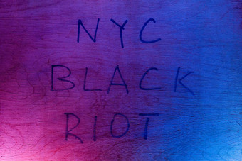 单词纽约黑色的<strong>防暴</strong>手写的黑色的油漆标记平胶合板表面红色的蓝色的警察灯概念