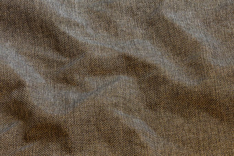 棕色（的）皱巴巴的密集的粗糙的织物特写镜头背景