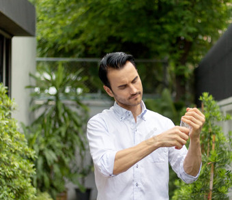 年轻的但浇水植物盆栽植物可回收的<strong>塑料瓶</strong>浇水植物扭曲的<strong>塑料瓶</strong>回收年轻的男人。工作花园