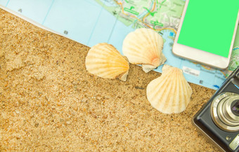绿色屏幕色度智能手机旅游地图相机贝壳沙子电话屏幕取代概念旅游