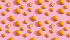 无缝的连续模式黄色的柠檬粉红色的背景极简主义概念新鲜的柑橘类水果