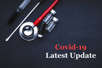 科维德冠状病毒最新的更新文本听诊器医疗拭子瓶黑色的背景
