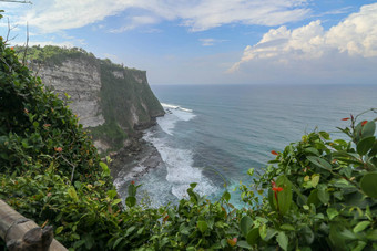 视图Uluwatu悬崖展馆蓝色的海<strong>巴厘岛</strong>印尼美丽的<strong>风景</strong>普拉崇高Uluwatu寺庙色彩斑斓的花前景一天<strong>风景</strong>优美的沿海景观高悬崖