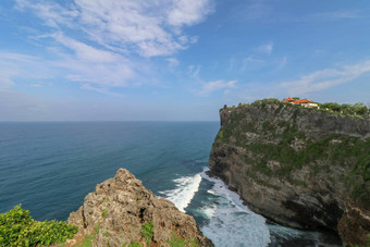 视图Uluwatu悬崖展馆蓝色的海<strong>巴厘岛</strong>印尼美丽的<strong>风景</strong>普拉崇高Uluwatu寺庙色彩斑斓的花前景一天<strong>风景</strong>优美的沿海景观高悬崖