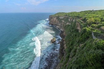 视图Uluwatu悬崖展馆蓝色的海<strong>巴厘岛</strong>印尼美丽的<strong>风景</strong>普拉崇高Uluwatu寺庙色彩斑斓的花前景一天<strong>风景</strong>优美的沿海景观高悬崖