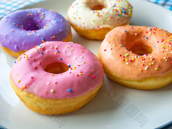甜甜圈味道颜色橙色白色紫色的粉红色的高能源食物健康的利率甜蜜的味糖果映射背景