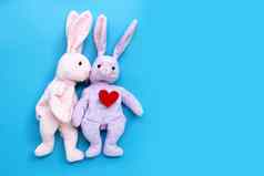 兔子玩具接吻红色的心蓝色的背景情人节