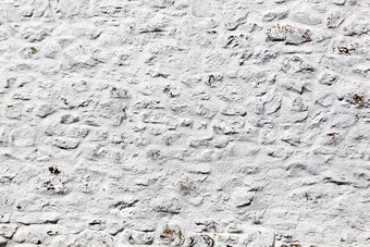 灰色白色饱经风霜的粗糙的石头墙纹理
