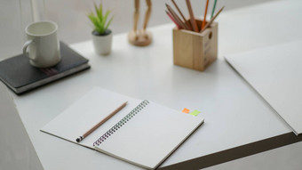 开放笔记本桌子上简单的工作空间完整的白