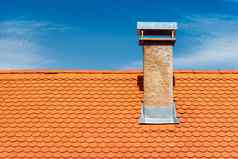 现代屋顶烟囱橙色陶瓷瓷砖瓦蓝色的天空背景
