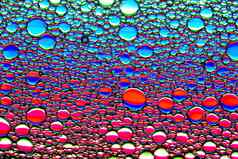 色彩斑斓的滴石油水圈椭圆摘要明亮的背景设计