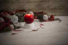 圣诞节设置红色的基斯蜡烛前景包围松分支机构红色的装饰物红色的白色丝带白色松视锥细胞圣诞节桌布散景效果