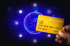 购物在线概念手持有黄色的信贷卡蓝色的技术背景
