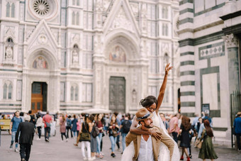 跨种族婚礼夫妇婚礼弗洛伦斯意大利非裔美国人新娘跳肩膀高加索人新郎广场的大教堂
