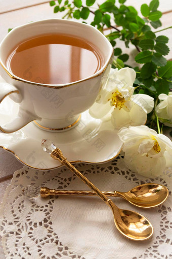 华丽的花束新鲜的玫瑰古董陶器陶瓷瓷投手金轮岁的板中国茶杯金勺子