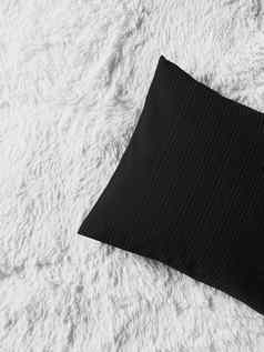 黑色的缓冲扔枕头白色毛茸茸的格子毯子平躺背景卧室前视图首页装饰