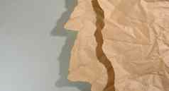 薄荷棕色（的）一块纸撕裂边缘影子灰色的背景摘要有创意的背景设计师