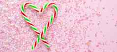 心使棒棒糖粉红色的背景闪闪发光的礼物一年圣诞节平躺