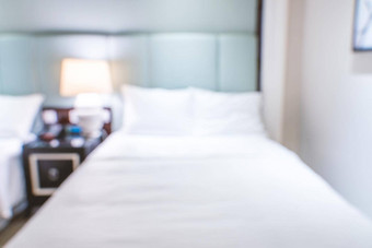 清洁舒适的现代酒店卧室室内双床上摘要散焦模糊散景背景设计概念奢侈品旅行