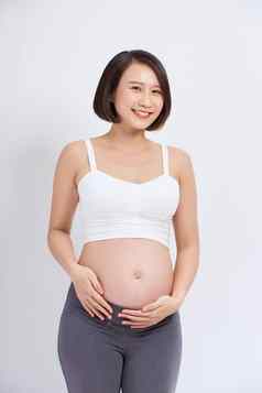 美丽的亚洲怀孕了女人期待婴儿触碰肚子