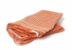 折叠橙色亚麻毛巾白色背景