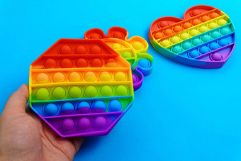 彩虹反压力玩具烦躁不安的人推硅胶玩具抗应激流行多彩色的背景