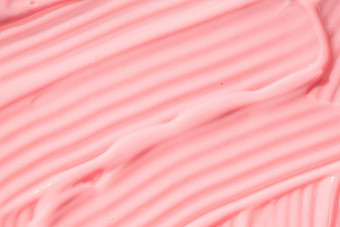 奶油粉红色的护肤品乳液摩丝产品特写镜头桃子奶油保湿霜传播防晒霜化妆品涂片背景保湿美噪音乳香斯沃琪粉红色的油漆酸奶纹理