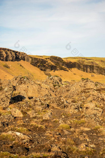 冰岛地形温暖的棕色（的）橙色音调岩石纹理蓝色的天空