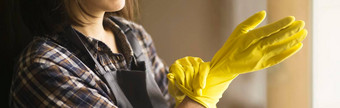 女人黄色的橡胶手套做家务