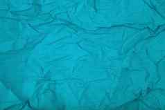 阿卡蓝色的皱巴巴的波纹包装纸背景空间文本
