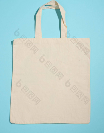 空亚麻生态友好的米色帆布手提包袋品牌蓝色的背景清晰的可重用的袋食品杂货模拟