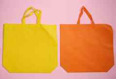 空粘胶生态友好的帆布手提包袋品牌粉红色的背景清晰的可重用的袋食品杂货模拟平躺