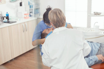 生病的病人坐着牙科椅子开放口口腔学过程