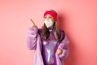 科维德时尚概念深刻的印象亚洲上了年纪的女人检查促销提供穿呼吸器冠状病毒指出左粉红色的背景