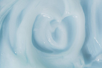 保湿美噪音乳香斯沃琪油漆纹理蓝色的奶油保湿霜洗发水传播防晒霜化妆品涂片背景