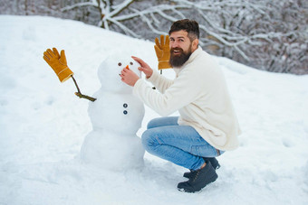 有趣的圣诞老人男人。摆姿势冬天天气男人。玩雪人冬天公园快乐圣诞节快乐假期